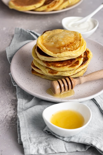 A stack homemade pancakes with honey