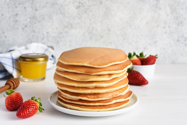 Stack of honey pancakes homemade strawberry pancakes for breakfast