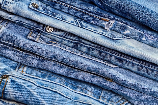 A stack of jeans as denim background or concept of buying selling shopping and trendy modern clothes