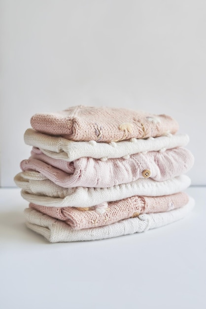 Stack of knitted clothes Baby clothes Needlework hobby knitting handwork