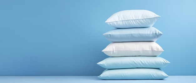 Photo a stack of light soft pillows for a comfortable and sound sleep on a light background with copy space