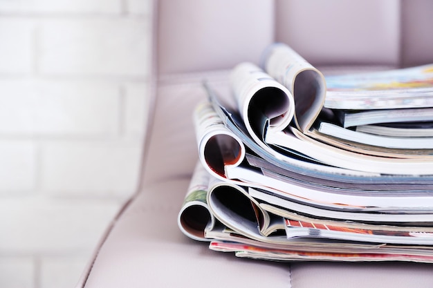 Stack of magazines on chair close up