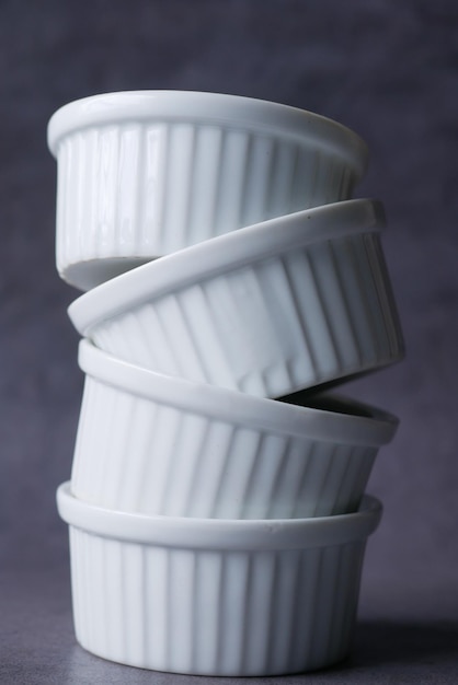 Stack of many white color bowl on table