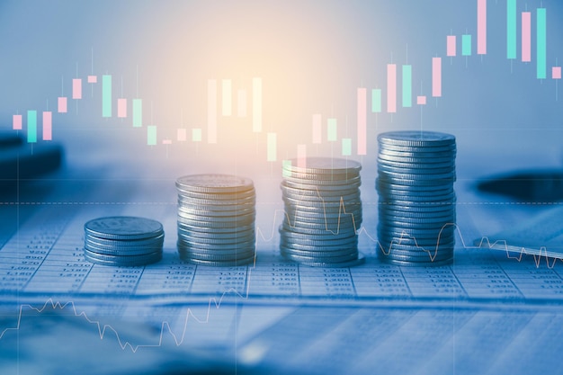 Stack of money coin on accounting sheet with trading graph financial investment concept