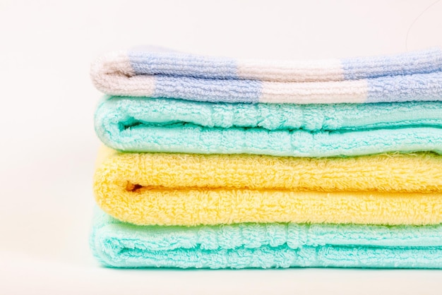 Stack of multicolored fluffy terry towels folded in a pile