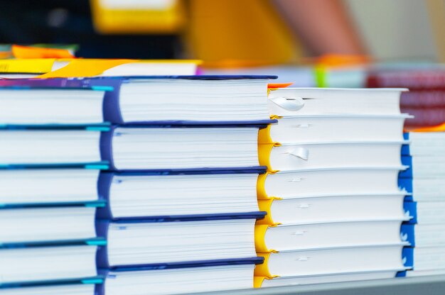 Photo stack of new books on the table. books on the forum of manufacturers of printed products.