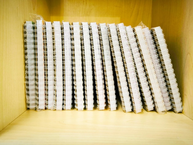 a stack of notebooks on the shelf