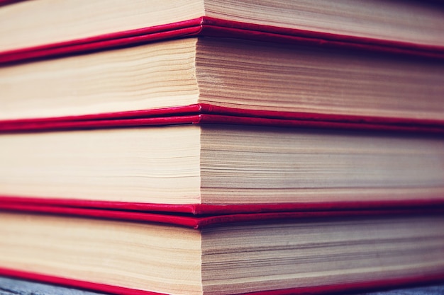 Stack of old books in red cover