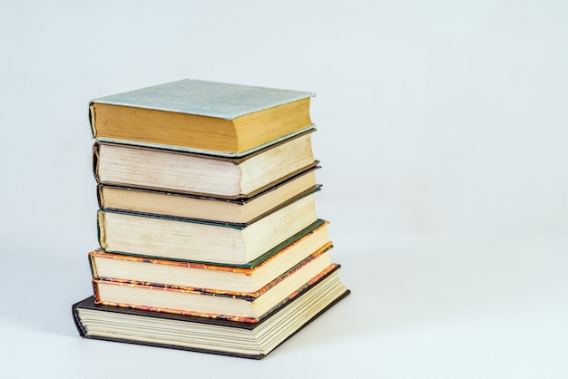 Stack of old books on white background