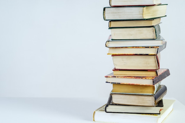 Stack of old books on white background