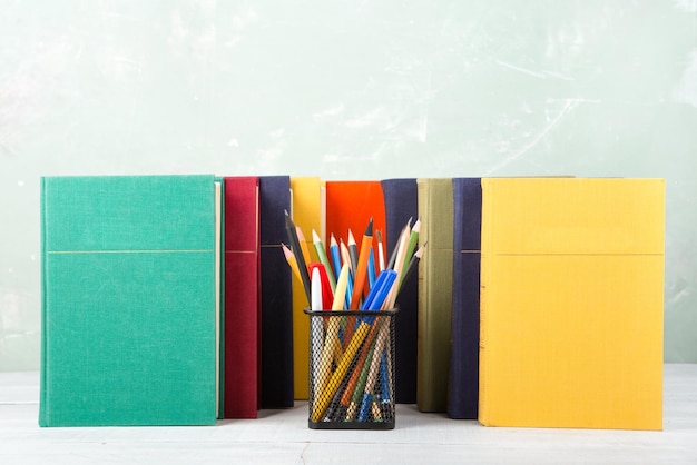 A stack of old color books and stationery on a table