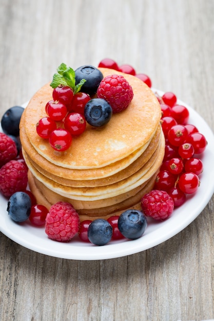 Stack of pancakes with blueberry and fresh berry.