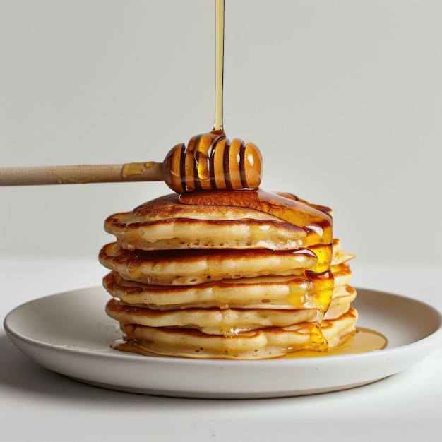 Photo stack of pancakes with maple syrup drizzle isolated on a white background