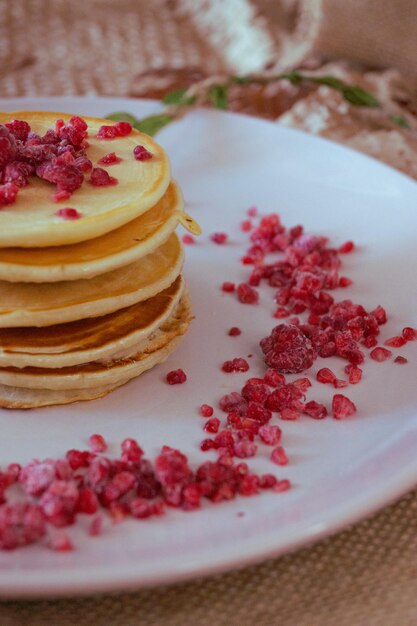 A stack of pancakes with raspberries