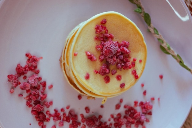 A stack of pancakes with raspberries