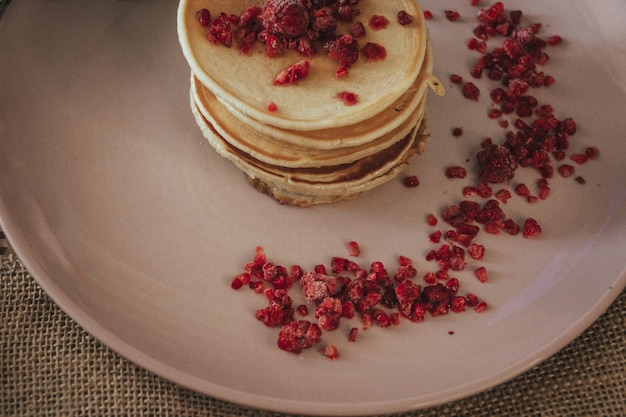 A stack of pancakes with raspberries