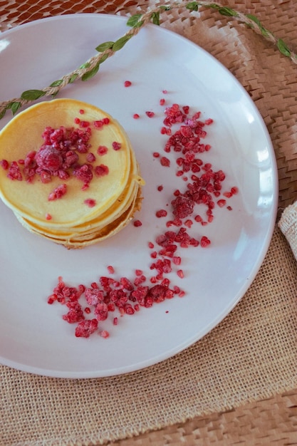 A stack of pancakes with raspberries