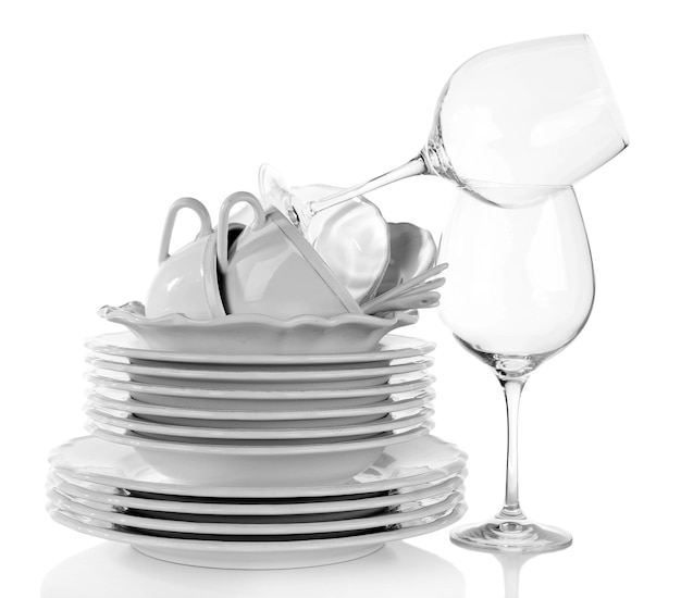 Stack of plates cups and wineglasses on white background