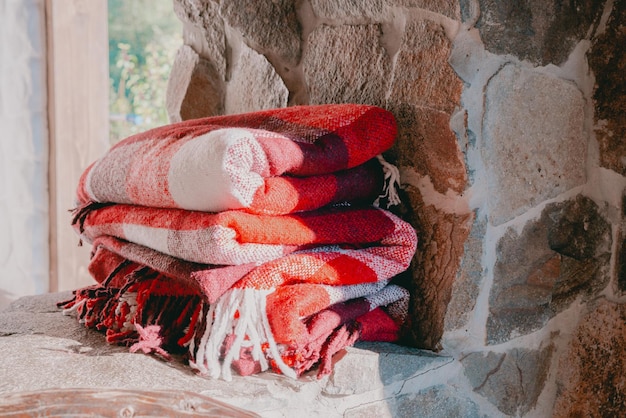 A stack of red checkered wool blankets lays down on a stone surface Clothes Cozy Home Vintage Winter Furniture Heat Order Soft Hobby Interior Autumn No People