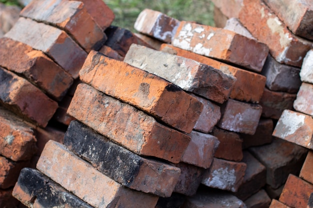 A stack of red not new fire bricks for laying a home stove.