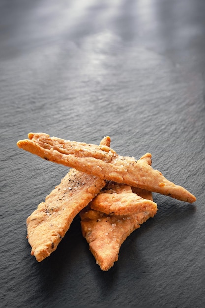 Stack of salty cheese cookies Cheese and salt cookies on a slate stone Healthy homemade food