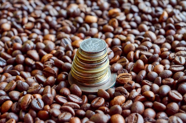 Stack of several coins on coffee beans