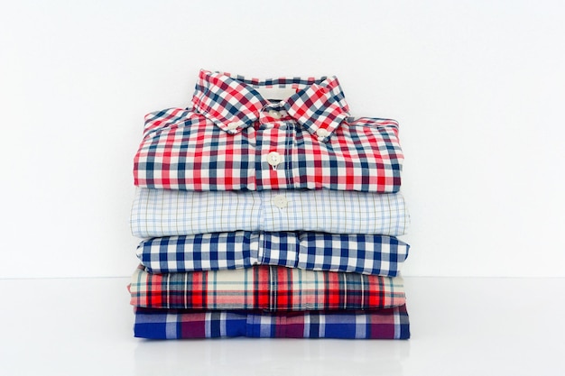 Stack of shirts on white background