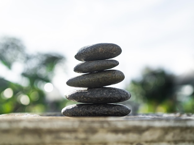 Stack Stone on Cement Wall BackgroundPyramid Rock CairnPebble SPiritualStabilityCalmMeditation Growth SymbolsPile Zen Design Smooth for Vacation Relaxation Nature Aroma therapy Spa Set Concept