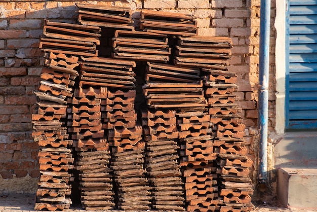 Stack of tiles a stack of tiles leaning against a brick wall with a beautiful texture in a small town in Brazil natural light selective focus