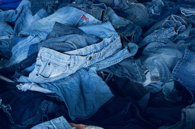 Stack of various shades blue jeans Pile Blue denim jeans texture banner Canvas denim fashion texture