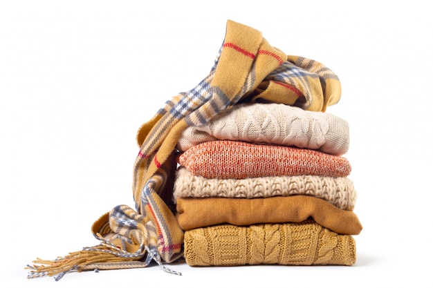 Stack of various sweaters and a scarf