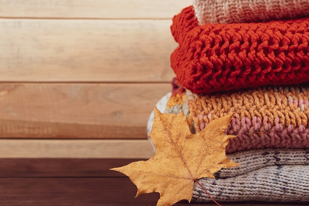 Stack of warm knitted sweaters