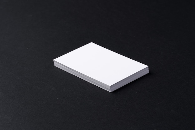 Stack of white business cards on black background