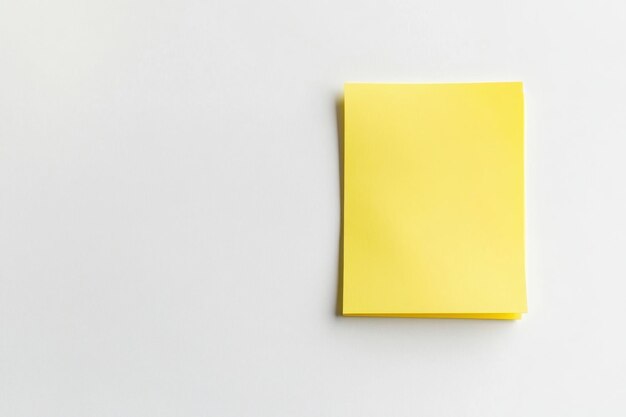 Photo a stack of yellow sticky notes on a clean white surface