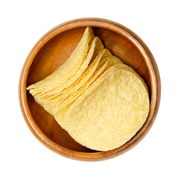 Stackable potatobased crisps in a wooden bowl