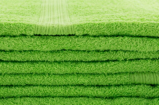 The stacked green towels, similar to lawn with green grass.