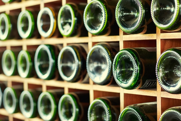 stacked of old wine bottles in the cellar