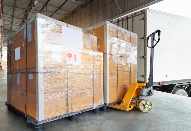 Stacked of package boxes on pallet rack waiting to load into shipping container Cargo shipment boxes