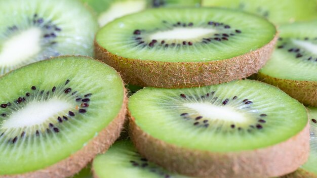 Stacked slices of kiwi fruit in a macro background and texture photo shot