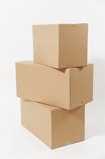 Stacked of three brown clear empty blank cardboard boxes isolated on white background. Receiving package. Copy space for advertisement. With place for text. Advertising area with workspace.