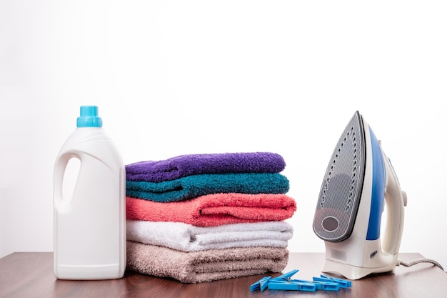 Stacked towels with liquid detergent, softener and iron