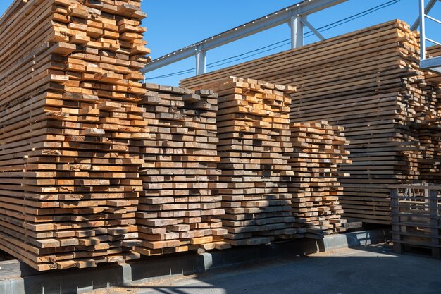 Photo stacked wooden planks closeup at lumber warehouse wood industry concept