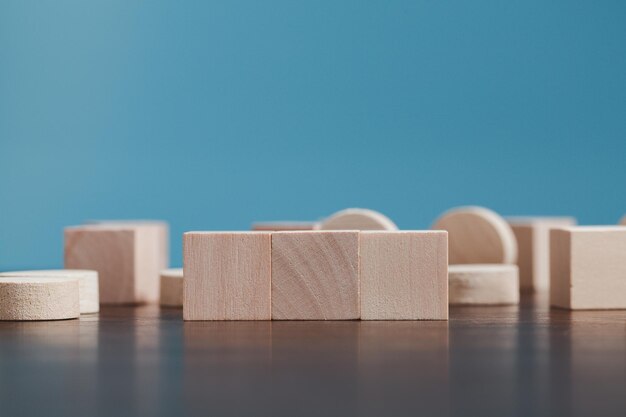 Stacking blank wooden cubes on blue background with copy space for input wording and infographic icon Empty brown wooden object block for symbol icon put technology zero gravity business concept