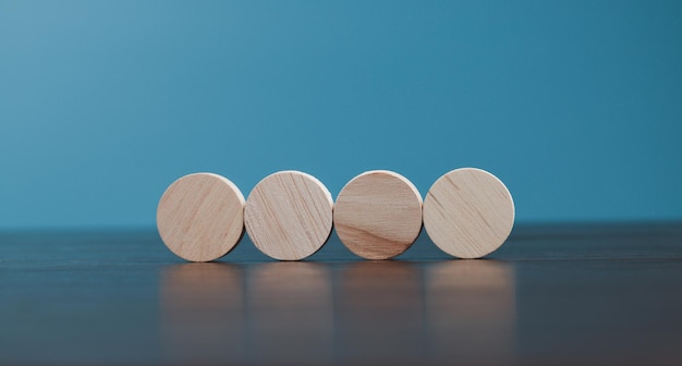 Stacking blank wooden cubes on blue background with copy space for input wording and infographic icon Empty brown wooden object block for symbol icon put technology zero gravity business concept