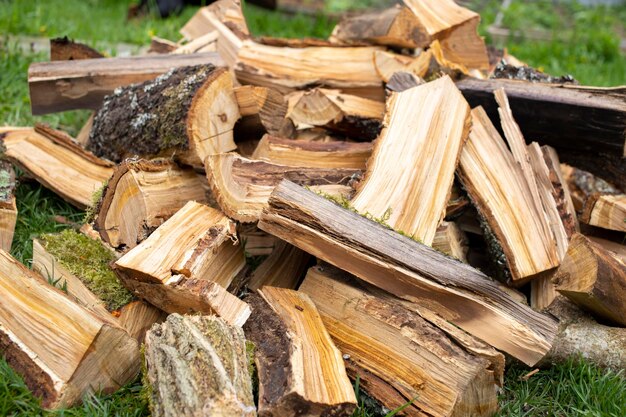 Stacking of round wood Dry cut wood texture Woodpile of light color core Wood storage place The structure of dry birch logs