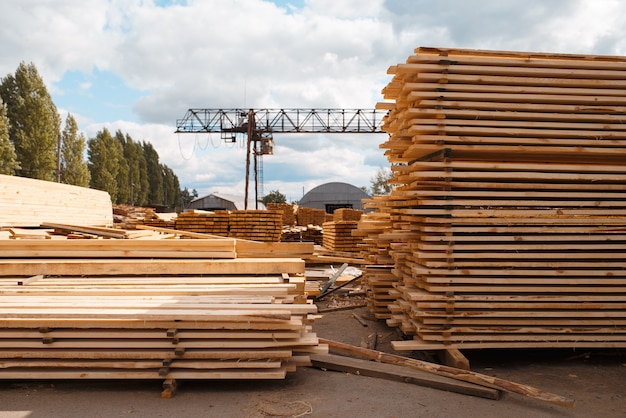 Stacks of boards on timber mill warehouse outdoor, nobody, lumber industry, carpentry. Wood processing on factory, forest sawing in lumberyard, sawmill