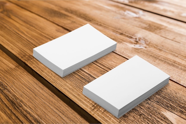 Stacks of business cards on wooden background