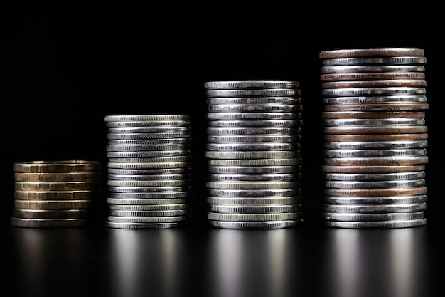 Stacks of metallic coins on a dark background