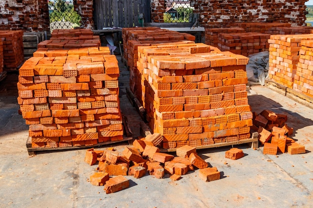 Stacks of new red brick at construction site