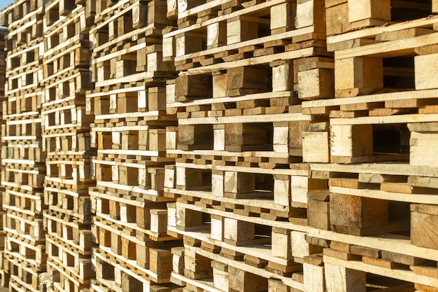 Stacks of wooden pallets in a warehouse yard of factory